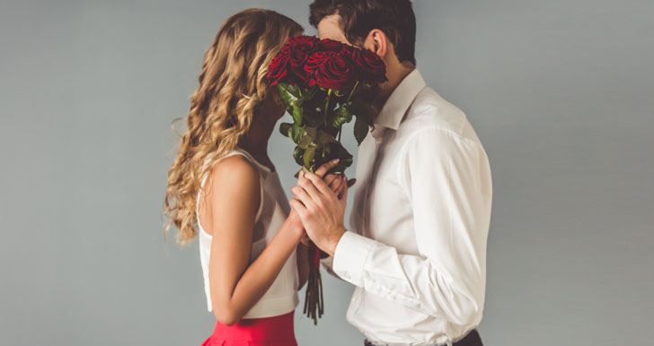 Couple behind flowers