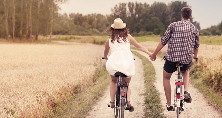 Couple riding bikes outdoors