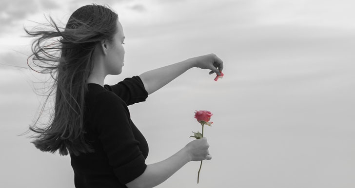 Woman plucking rose
